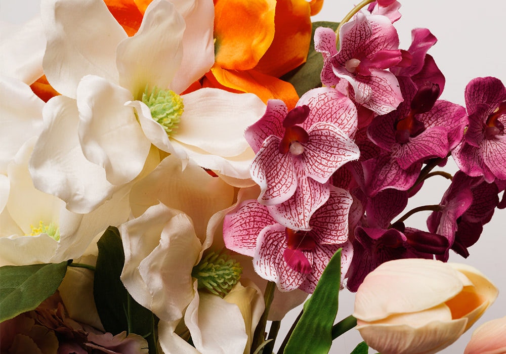 A woman handles the leaves of an average-sized floral bouquet